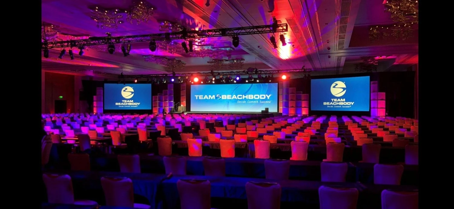 Branded event stage with screens on either side