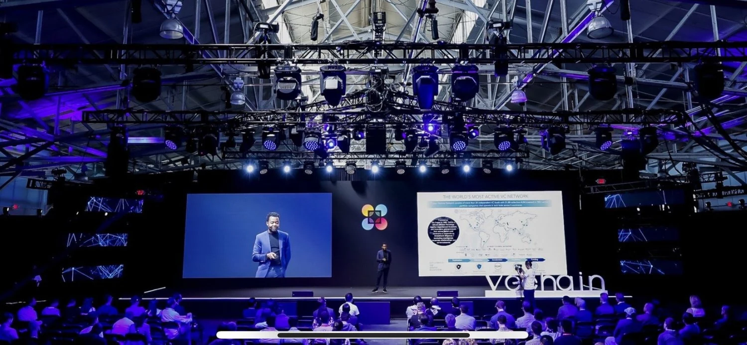 Live presenter feed displayed beside presentation content at an event